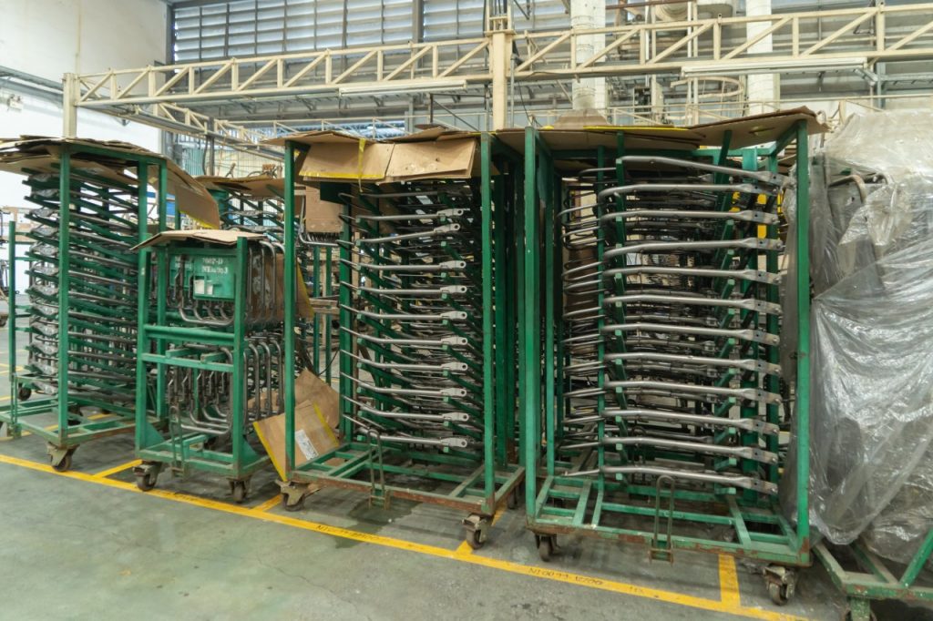 Industrial carts with ultrasound tracking beacons in manufacturing warehouse facility